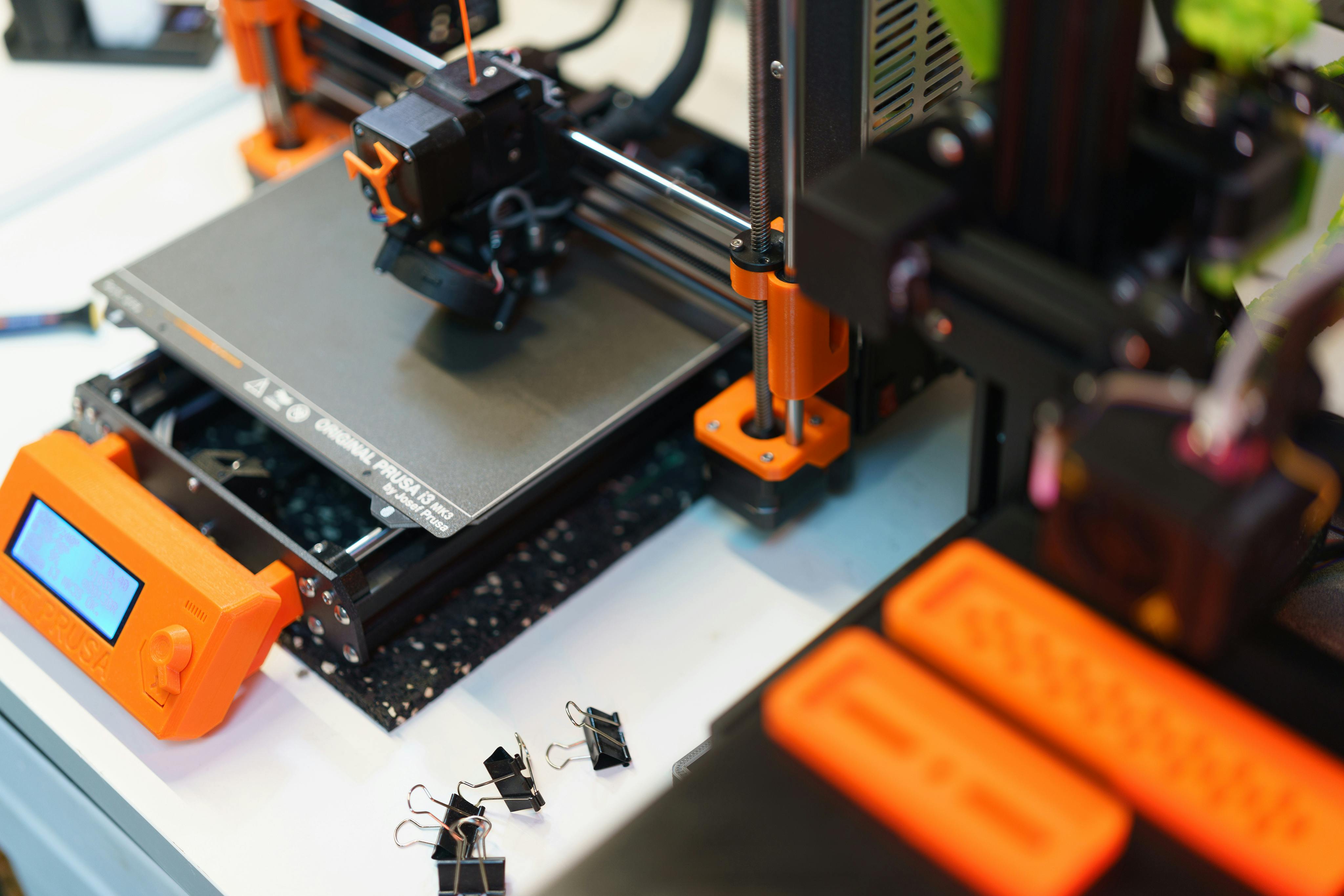 A 3D printer workspace with tools and filament nearby